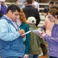 Braden Callis takes notes on a Market Steer class