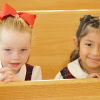 Scout Cullen and Samantha Hernandez get ready for Mass to start