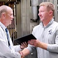 Matt Goucher, left, presents Dallas Curtis with a certificate 