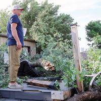 Darren Koehn stands on top of his pool deck looking over the damage to his property