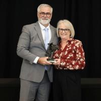 Dan Mabery presents the Natalea Watkins Communicator of the Year to Dayna Rowe