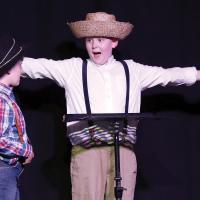 Tom Sawyer, played by Garrett Wells, tells Huckleberry Finn (Coen Taylor) about how they are going to get back at Becky Thatcher