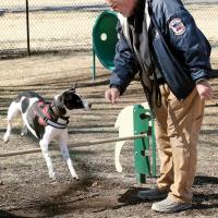 Joe Dion holds out a treat for his dog Hunter 