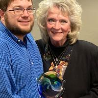 Dustin Downey presents the state award to Vicki Proctor
