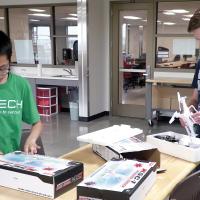 Muhammad Nayaka (left) and Travis Lloyd inspect new drones