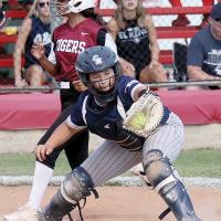 Bailey Brothers grasps the ball in her glove after a throw to the plate
