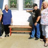 James Elliott, Nikki Pruitt, John Henderson and DeDe Henderson stand by the engraved wooden bench