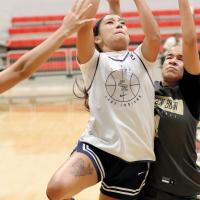 Juliana Thomas slices her way between Broken Bow defenders to shoot a driving layup