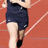 Kaylee Randall stretches toward the finish line in the 100-meter dash