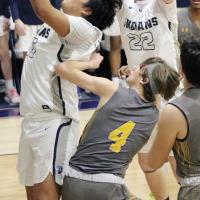 James Reveles pulls down a rebound in front of teammate Jacob Robertson