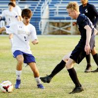 Logan Singletary passes the ball in front of a Noble player