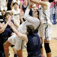 Tre Davis shoots a put-back over teammate James Reveles