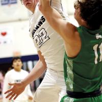 Jacob Robertson swipes a rebound away from an Irish player