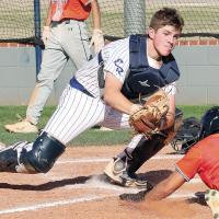 Gage Lesperance cups the ball while stretching out to tag a Guymon runner