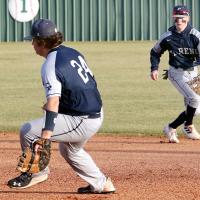 Palmer Ellis pulls off the plate as Devin Shamblin runs over to field a grounder
