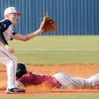 Boston Ellison eyes a pickoff throw as a base runner slides into second