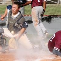Brayden Fulton uses his chest protector to knock down a throw to the plate