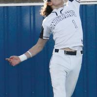 Dacien Ramos leaps at the wall of the Hub Reed Complex while trying to snag a fly ball