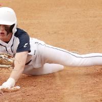 Gavin Tinsley tries to slide headfirst under a tag at third