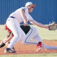 Garrett March eyes a pickoff throw as a Titans runner slides into second