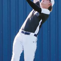 Preston Ashford reaches back while jumping in the air to catch a flyball 