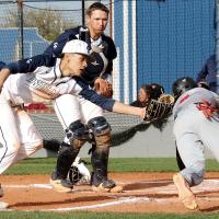 Vincent Walker attempts to make a tag on a runner trying to slide into home