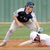 A Duncan base runner tries to slide under the tag of Dawson Davidson on a stolen base attempt
