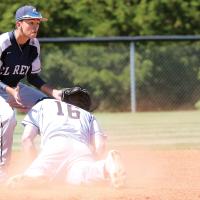 Jovanny Rosas leans down to block a throw from the outfield