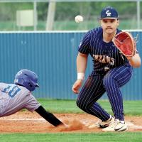 Jonathan Shelley looks a pickoff throw into his glove