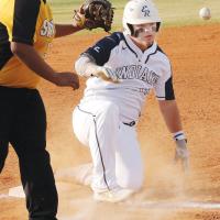 Dacus Cooper slides into third base ahead of a pickoff throw