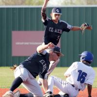 Dacus Cooper tags out a runner while teammate Vincent Walker signals the call