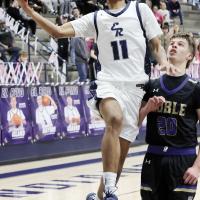 Leo Willis jumps past a Noble defender on a layup attempt