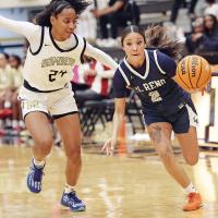 Juliana Thomas makes a hard dribble around a Midwest City player