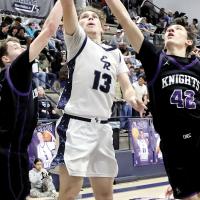 Gabe Osburn splits two Oklahoma City Knights defenders on a drive to the basket