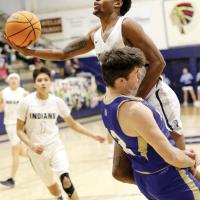 Diante Palmer tries to jump around contact with a player