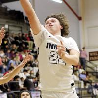Jacob Robertson stretches the ball toward the basket on a layup attempt