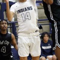 Evan Roman Nose tries to put up a shot in front of a block attempt
