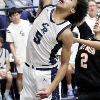 Jacob Nichols (5) stretches his hand over the rim to catch a rebound for a put-back goal