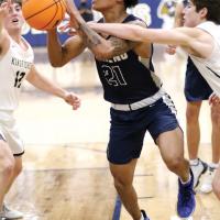Dorian Plumley eyes the basket while getting fouled