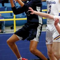 Carter Roman Nose eyes the basket while shooting a fastbreak layup