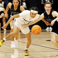 Evan Roman Nose pushes his way past a Shawnee player