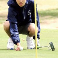 Bryan Richardson places the ball down on the green