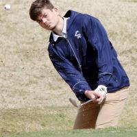 Dallon Biswell blasts through a wave of sand while hitting out of the trap