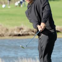Jacen Bear chips onto the 16th green at Crimson Creek Golf Course