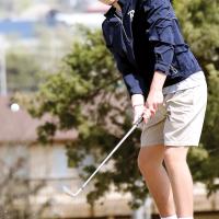 Dallon Biswell chips off a hill on the side of the fifth green at Crimson Cree