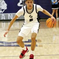 Carter Roman Nose works the ball up the court