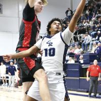 Jonathan Reed shoots a fastbreak layup as he is hit by a Titans defender