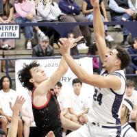 Tre Davis shoots over the block of an Elgin defender