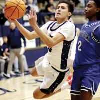 Carter Roman Nose leaps around a GHS defender to attempt a one-handed shot