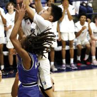 Carter Roman Nose jumps between two defenders to get off a shot